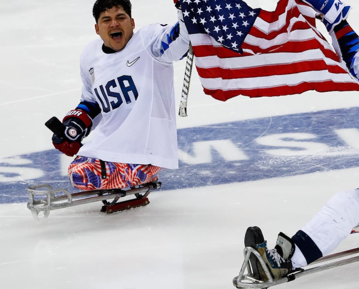 Ralph DeQuebec holding American flag